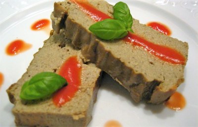 Il papeton di melanzane servito a fette con salsa di pomodoro